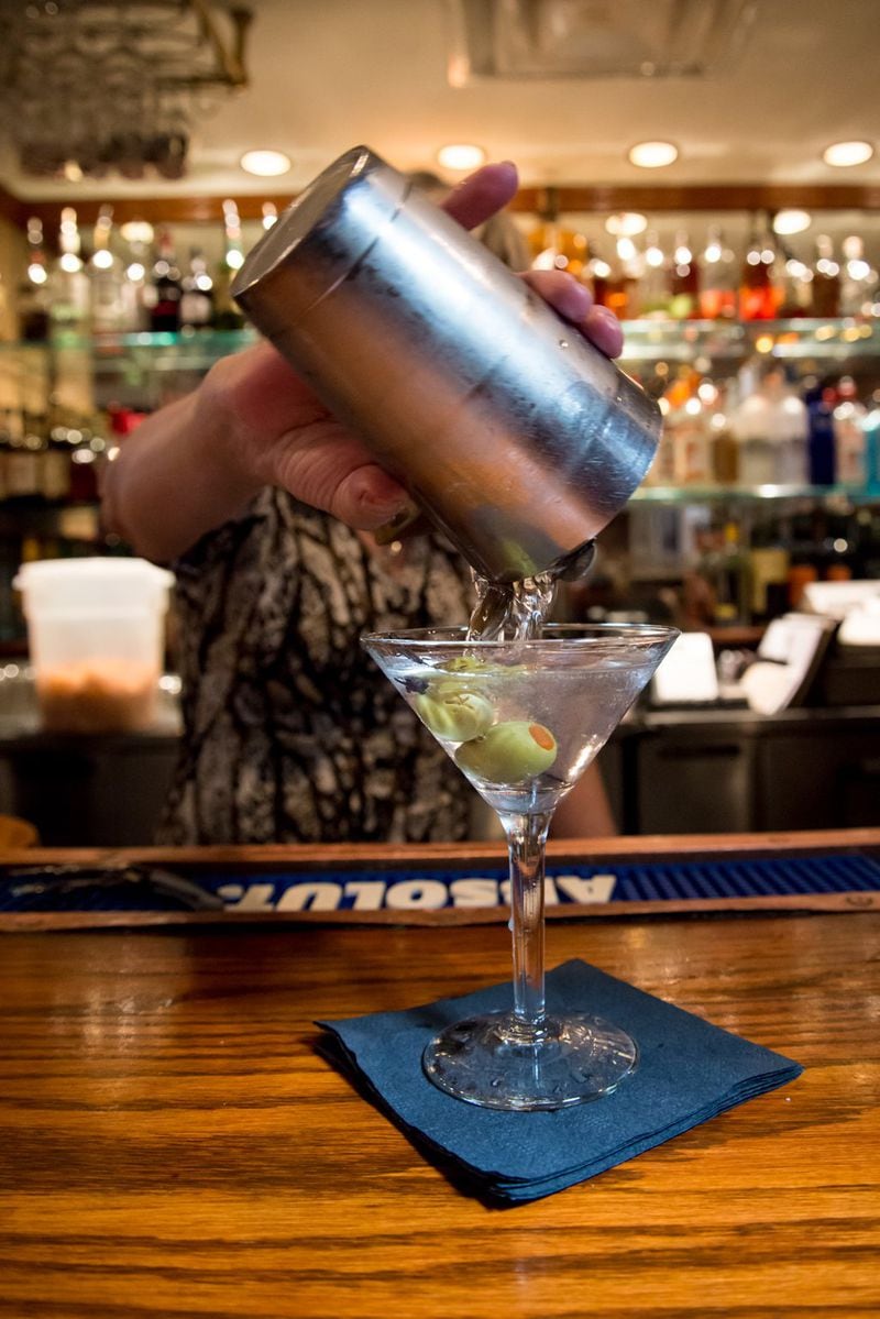 A bartender at the Colonnade pours the classic gin martini at the bar. CONTRIBUTED BY MIA YAKEL