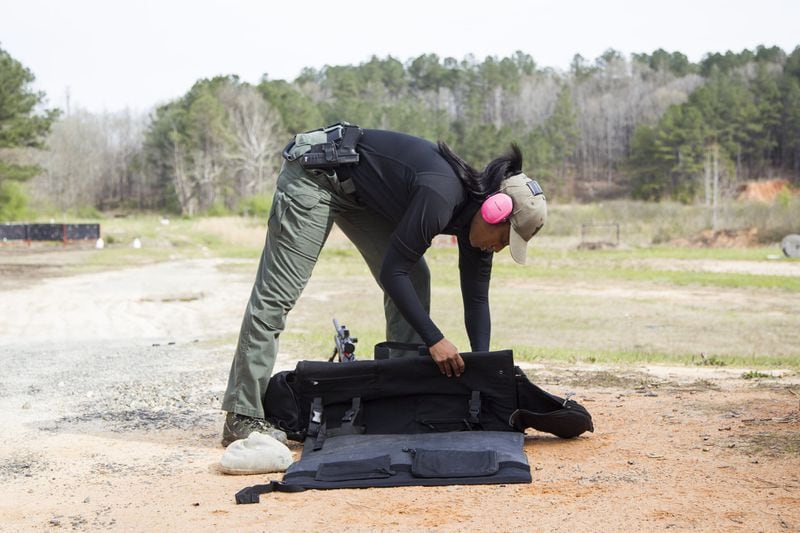 LaShira Norwood, 31, a Fulton County deputy, prepares her sniper equipment at the David L. Hagins Firing Range in Atlanta, Georgia, on Monday, April 2, 2018. Norwood is Fulton County Sheriff Office’s first female sniper. (REANN HUBER/REANN.HUBER@AJC.COM)