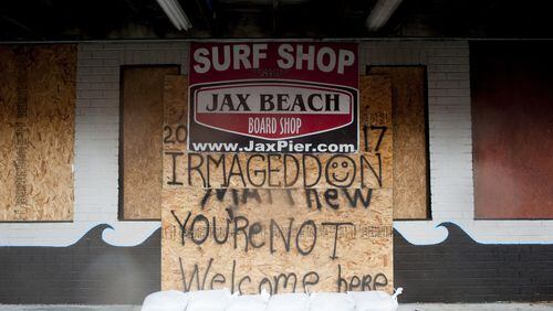 A surf shop, reusing plywood from Hurricane Matthew preparation, boarded up ahead of Hurricane Irma’s arrival in Jacksonville Beach, Fla. JOHNNY MILANO / THE NEW YORK TIMES