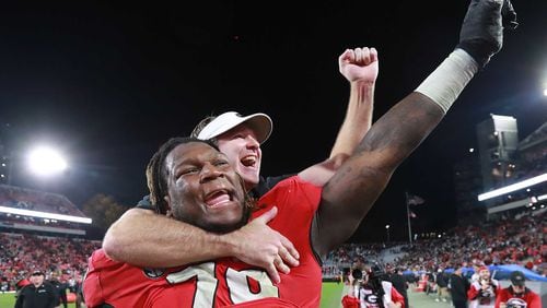 Georgia head coach Kirby Smart jumps on the back of offensive lineman Isaiah Wilson to celebrate beating Texas A&M 19-13 on Saturday, November 23, 2019, in Athens. Curtis Compton/ccompton@ajc.com