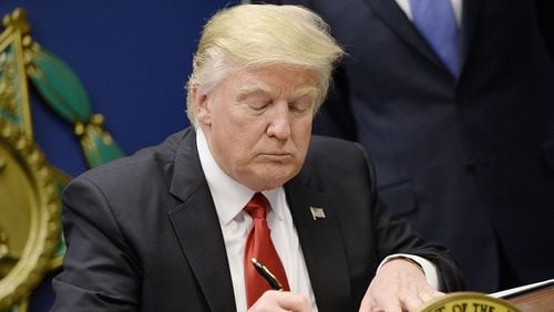ARLINGTON, VA - JANUARY 27: U.S. President Donald Trump signs executive orders in the Hall of Heroes at the Department of Defense on January 27, 2017 in Arlington, Virginia. Trump signed two orders calling for the "great rebuilding" of the nation's military and the "extreme vetting" of visa seekers from terror-plagued countries. (Photo by Olivier Douliery-Pool/Getty Images)