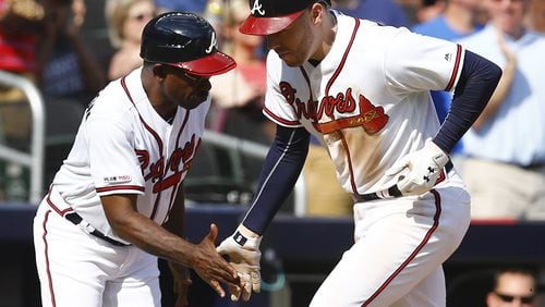 ATLANTA, GEORGIA - JUNE 01: First baseman Freddie Freeman #5 of the Atlanta Braves is congratulated by third base coach Ron Washington #37 after hitting a 2-run home run in the fourth inning during the game against the Detroit Tigers at SunTrust Park on June 01, 2019 in Atlanta, Georgia. (Photo by Mike Zarrilli/Getty Images)