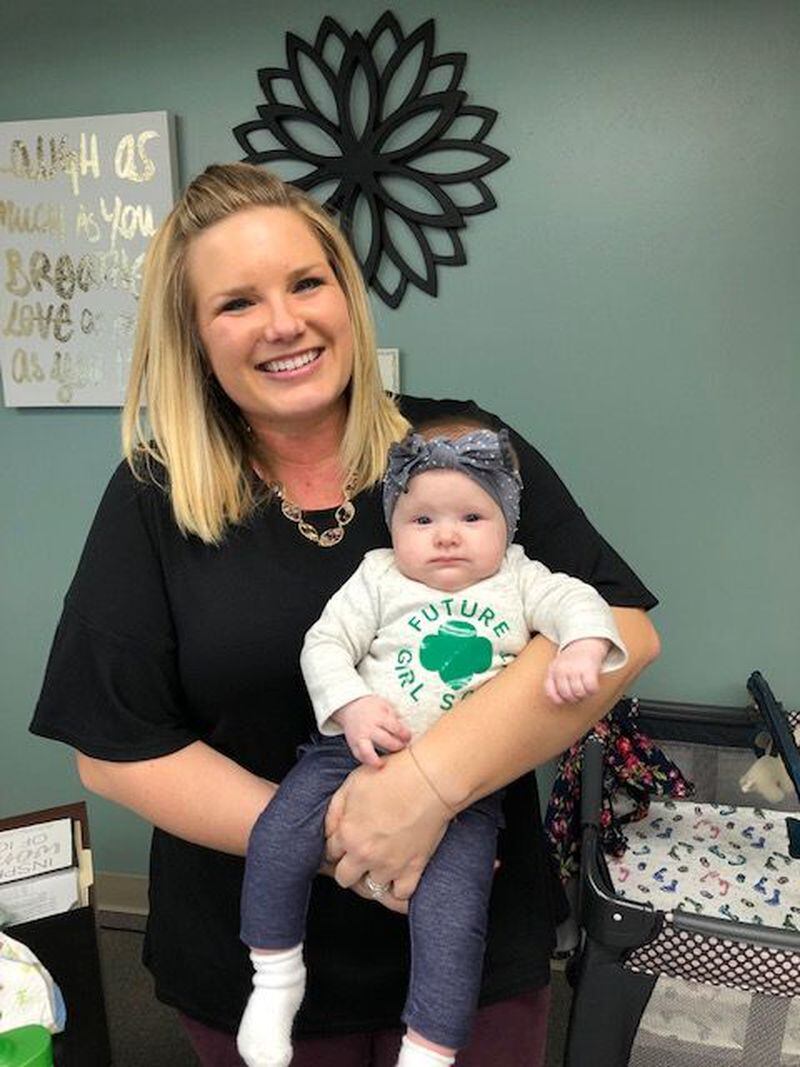 Chelsey DeRuyter poses with her 14-week-old daughter, Finley, at Girl Scouts of Greater Iowa.