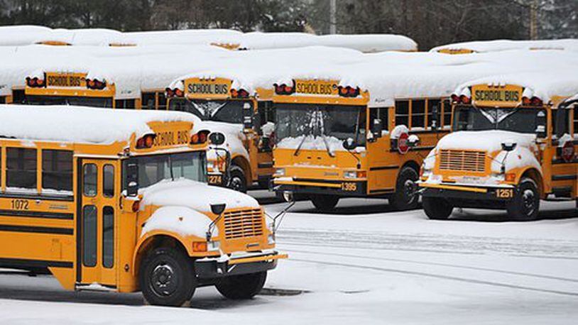 Snow-covered Cobb County school buses remained parked Monday morning, January 10, 2011.