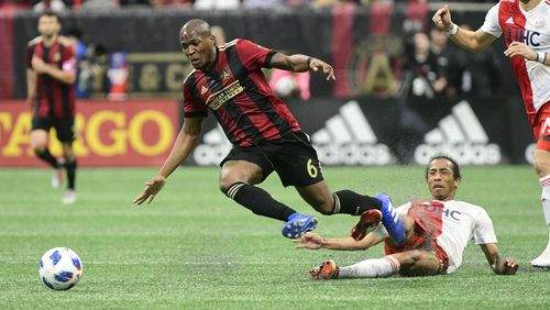 Atlanta United midfielder Darlington Nagbe (6) gets tripped up against the New England Revolution during the first half Saturday, Oct. 6, 2018, at Mercedes-Benz Stadium in Atlanta.