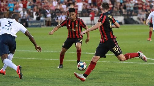 July 10, 2019 Kennesaw: Atlanta United midfielder Emerson Hyndman (center) gets the assist passing it off to midfielder Gonzalo Martinez (left) for the goal and a 1-0 lead over St. Louis in a U.S. Open Cup quarterfinals soccer match on Wednesday, July 10, 2019, in Kennesaw. Atlanta United won the match 2-0. Curtis Compton/ccompton@ajc.com