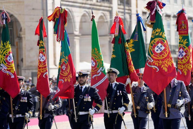 Standard-bearers open a military parade at Lisbon's Comercio square, Thursday, April 25, 2024, during celebrations of the fiftieth anniversary of the Carnation Revolution. The April 25, 1974 revolution carried out by the army restored democracy in Portugal after 48 years of a fascist dictatorship. (AP Photo/Armando Franca)