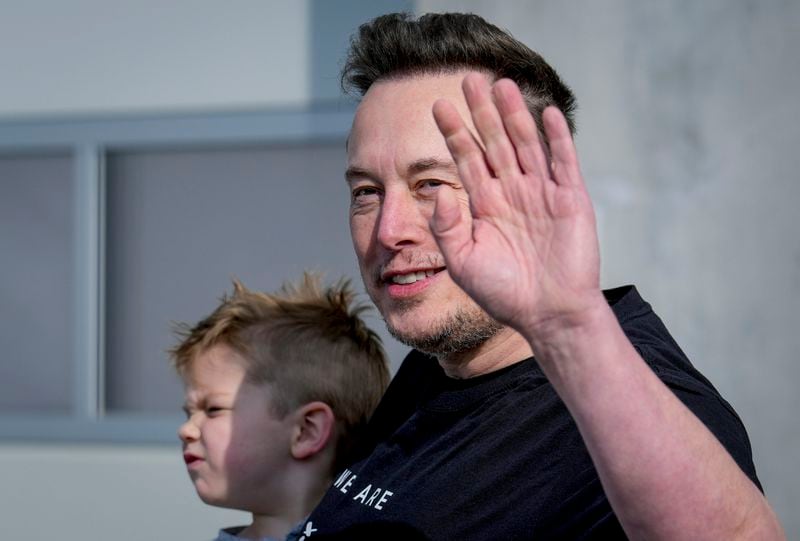 FILE - Tesla CEO Elon Musk waves as he leaves the Tesla Gigafactory for electric cars after a visit in Gruenheide near Berlin, Germany, March 13, 2024. After reporting dismal first-quarter sales, Tesla is planning to lay off about a tenth of its workforce as it tries to cut costs, multiple media outlets reported Monday. (AP Photo/Ebrahim Noroozi, File)