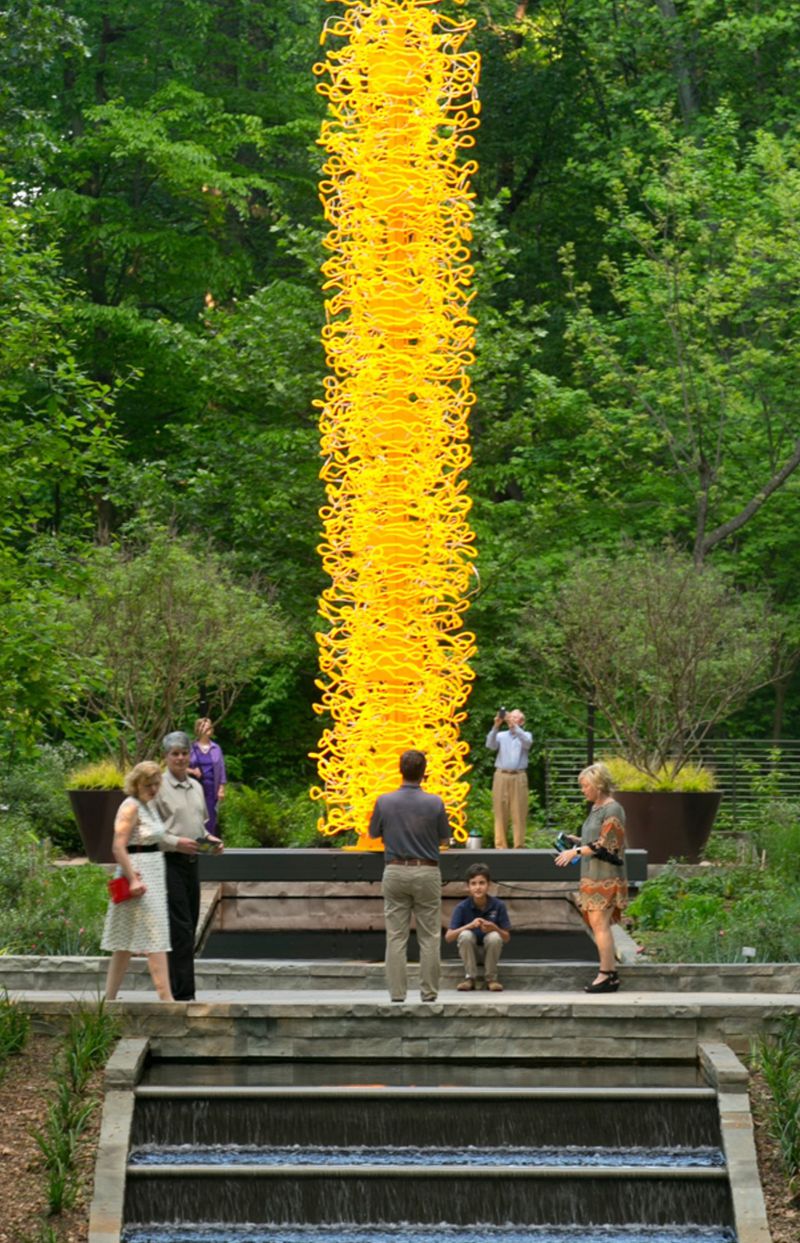 Chihuly's glass sculpture, "Saffron Tower," is composed of 312 hand-formed neon tubes. CONTRIBUTED: ATLANTA BOTANICAL GARDEN