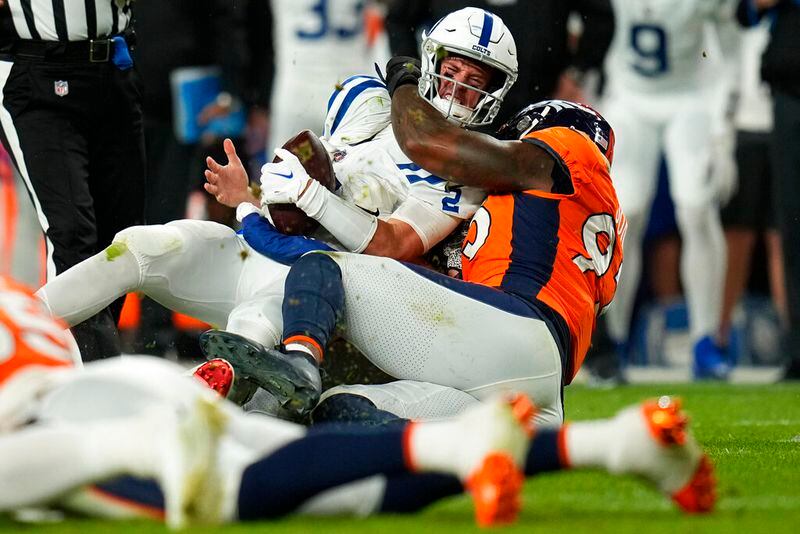 Indianapolis Colts quarterback Matt Ryan is sacked by Denver Broncos defensive end Dre'Mont Jones, right, during the first half of an NFL football game, Thursday, Oct. 6, 2022, in Denver. (AP Photo/Jack Dempsey)