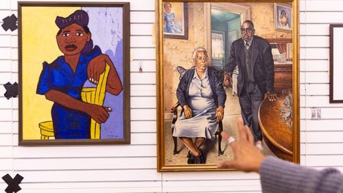 These paintings, pictured at the Clark Atlanta Art Museum, will be going to the Metropolitan Museum of Art. The image on the left, "Woman in Blue" by William H. Johnson, is the featured image for the Met's promotional material of the exhibit. (Arvin Temkar / arvin.temkar@ajc.com)