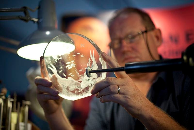 An engraver works on a Waterford crystal bowl at the factory in Waterford, Cork. (Tourism Ireland)