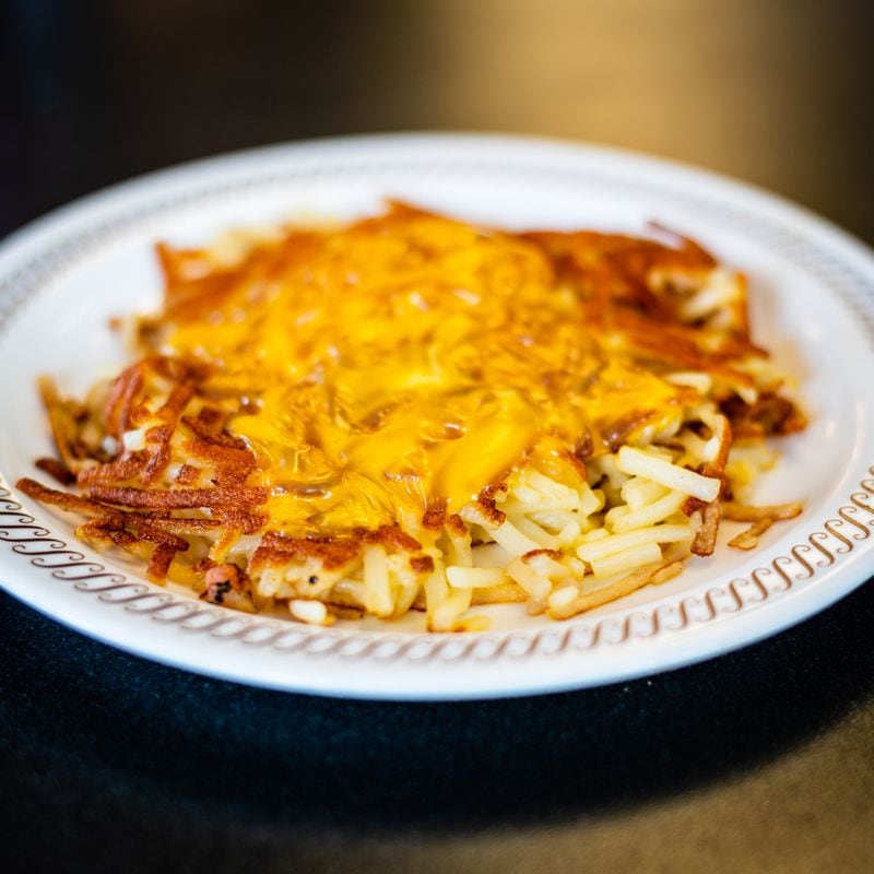 Covered hash browns from Waffle House with melted cheese.