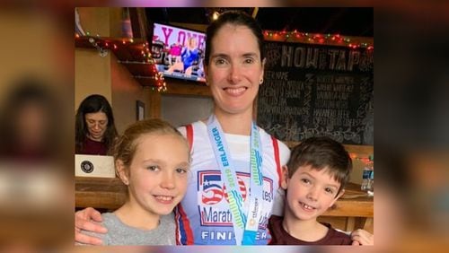 Elizabeth Simon, a Cox Communications executive, ran 50 marathons in 50 states, finishing in Chattanooga, Tenn. Sunday. Her four children and husband ran alongside her for various stretches of the 26.2-mile race. Her daughter Brianna, 10 and son Alan, 8, are shown. (Photo provided by Elizabeth Simon)