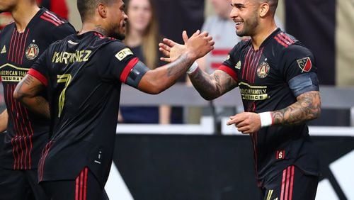 022722 : Atlanta United attacker Dom Dwyer (right) gets five from fellow attacher Josef Martinez after scoring a goal for a 2-0 lead over Sporting KC in a MLS soccer match on Sunday, Feb. 27, 2022, in Atlanta.  “Curtis Compton / Curtis.Compton@ajc.com”`