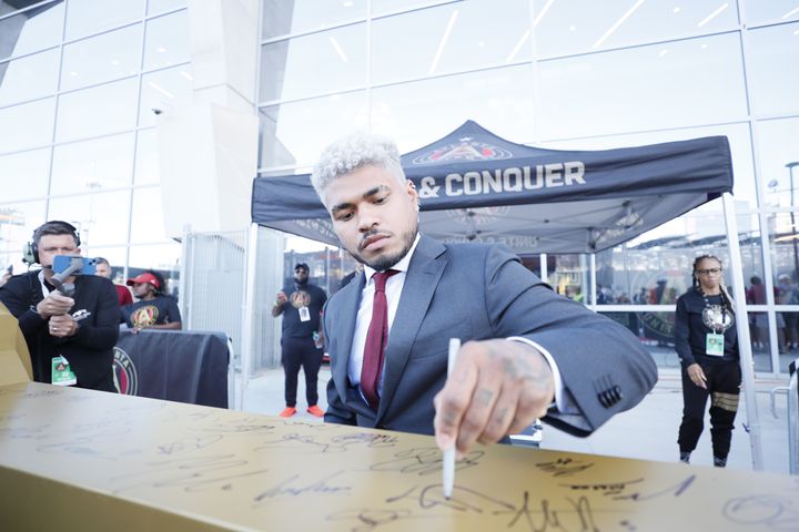 Atlanta United forward Josef Martinez signs the golden spike as the team arrives at the Mercedes-Benz Stadium before the game against the Columbus Crew on Saturday, May 28, 2022.