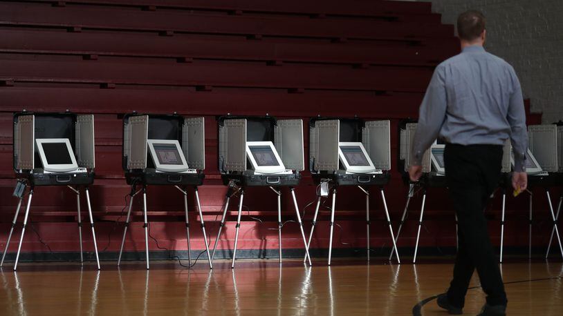 July 24, 2018 - Atlanta, Ga: A voter walks toward the voting booths during the Georgia runoff election voting at Henry W. Grady High School Tuesday, July 24, 2018, in Atlanta. (JASON GETZ/SPECIAL TO THE AJC)
