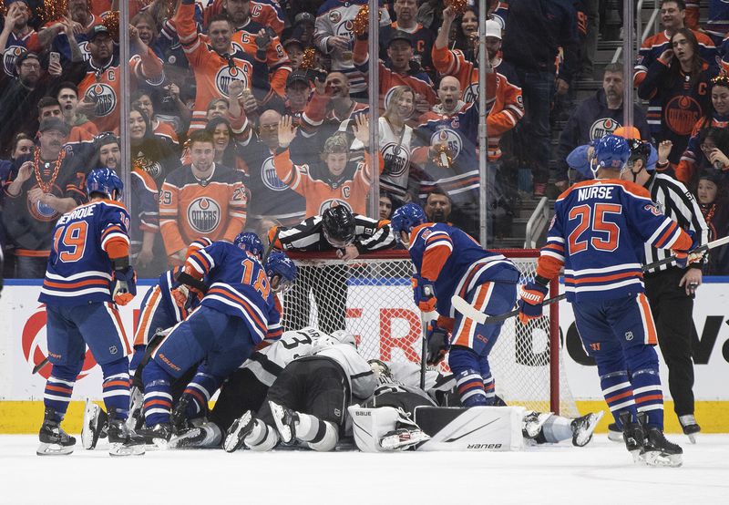 Los Angeles Kings and Edmonton Oilers scramble for the puck during the first period of Game 2 of an NHL hockey Stanley Cup first-round playoff series Wednesday, April 24, 2024, in Edmonton, Alberta. (Jason Franson/The Canadian Press via AP)