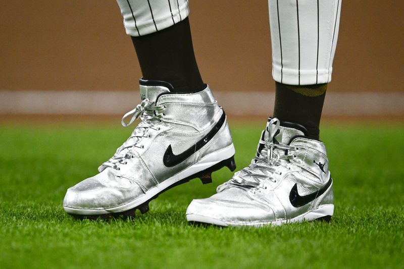 FILE - San Diego Padres' Fernando Tatis Jr. (23) wears silver Nike cleats during a baseball game against the St. Louis Cardinals, Monday, April 1, 2024, in San Diego. Tatis plans to unveil 50 pairs of custom cleats this season in conjunction with his branding company, Xample, and Los Angeles-based Shoe Surgeon. The cleats will honor people, events and whatever strikes the 25-year-old Tatis' fancy. (AP Photo/Denis Poroy, File)