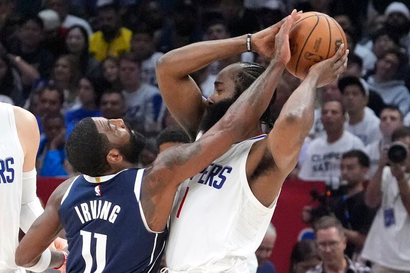 Dallas Mavericks guard Kyrie Irving, left, reaches in on Los Angeles Clippers guard James Harden during the second half in Game 5 of an NBA basketball first-round playoff series Wednesday, May 1, 2024, in Los Angeles. (AP Photo/Mark J. Terrill)