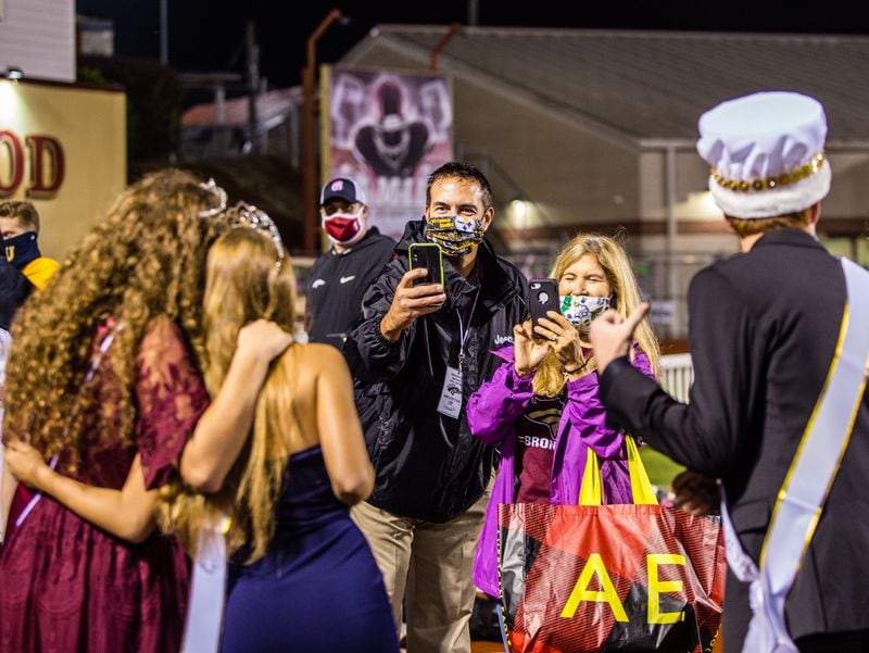 Brookwood High School in Snellville celebrates homecoming without a parade or a dance Friday, Oct 9, 2020.  Parents get pictures of the new homecoming court as they come off the football field. (Jenni Girtman for The Atlanta Journal-Constitution)
