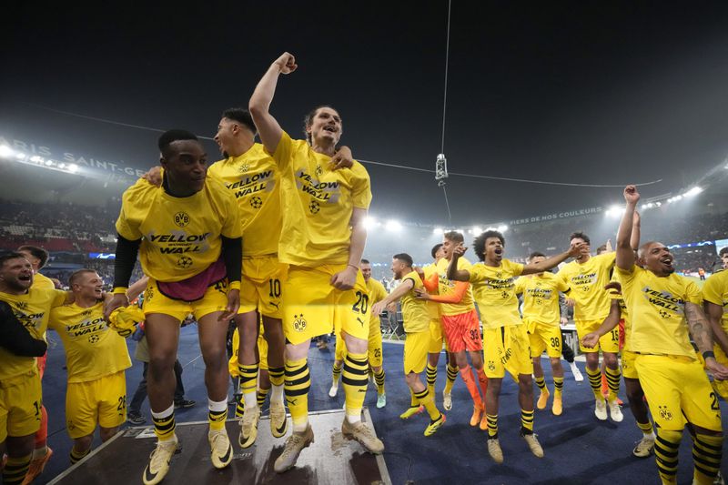 Borussia Dortmund players celebrates at the end of the Champions League semifinal second leg soccer match between Paris Saint-Germain and Borussia Dortmund at the Parc des Princes stadium in Paris, France, Tuesday, May 7, 2024. (AP Photo/Frank Augstein)