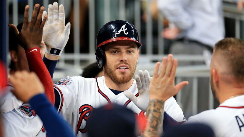 Hot-hitting first baseman Freddie Freeman was out of the Braves lineup Saturday due to a stomach virus.