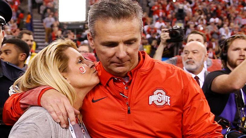 Ohio State Buckeyes head coach Urban Meyer gets a kiss after his team's 27-21 Big Ten Champsionship win over the Wisconsin Badgers at Lucas Oil Stadium Sunday, Dec. 3, 2017 in Indianapolis. (Sam Riche/TNS)