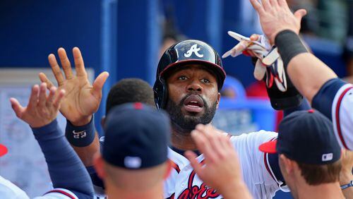 Jason Heyward gets high fives in the dugout scoring on a RBI double by Freddie Freeman for a 1-0 lead over the Twins in the first inning on Tuesday, May 21, 2013, in Atlanta. Heyward got a day of rest for Monday’s series opener against the Blue Jays.