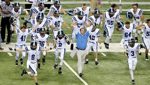 As time expires, Lovett coach Mike Muschamp, center, and players celebrate their 14-7 win over Lamar County at the Georgia Dome in Atlanta on Saturday, December 14, 2013.