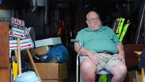 Willie Davis, a U.S. Navy veteran who is dying from cancer, sits in his garage among many of his belongings, which he's trying to sell to help pay for his own funeral, Wednesday, Sept. 26, 2018, in Johnstown, Pa. (John Rucosky/Tribune-Democrat via AP)