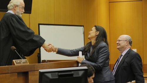 APS superintendent Meria Carstarphen shakes the hand of DeKalb County Judge Alan C. Harvey on Friday after he gave Fulton County permission to send tax bills.