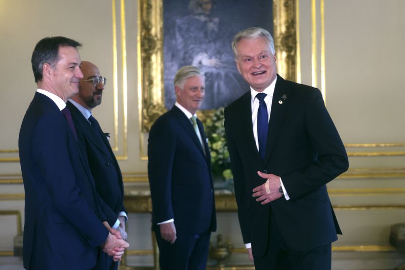 Lithuania's President Gitanas Nauseda, right, is greeted by, from left, Belgium's Prime Minister Alexander De Croo, European Council President Charles Michel and Belgium's King Philippe during a reception at the Royal Palace prior to an EU summit in Brussels, Wednesday, April 17, 2024. (Olivier Hoslet, Pool Photo via AP)
