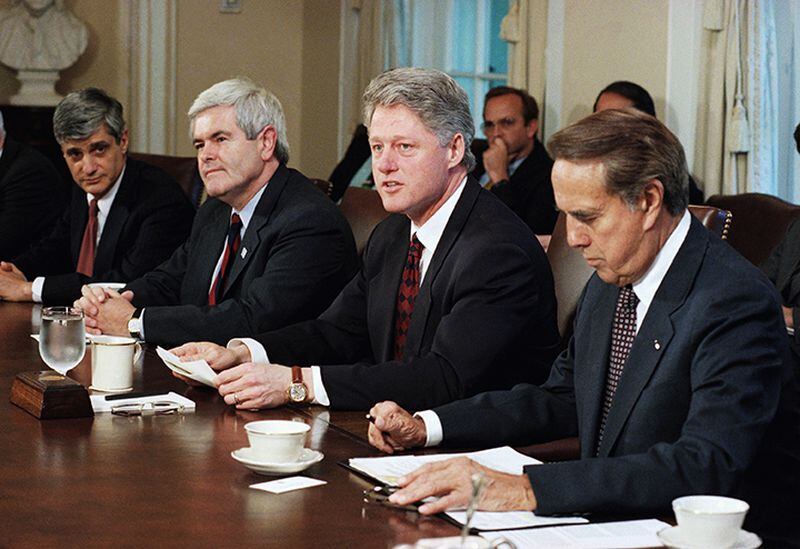 In this April 26, 1995 file photo, President Bill Clinton meets with congressional leaders in the Cabinet Room of the White House in Washington. From left are, Treasury Secretary Robert Rubin, House Speaker Newt Gingrich of Ga., the president, and Senate Majority Leader Bob Dole of Kansas. Disputes over spending and health care in a divided Washington have triggered shutdowns of the federal government in recent years. Republicans now control the White House and Congress, and if lawmakers and President Donald Trump fail to agree on a spending bill by midnight Friday, a shutdown of an all-GOP government would occur for the first time in modern history.