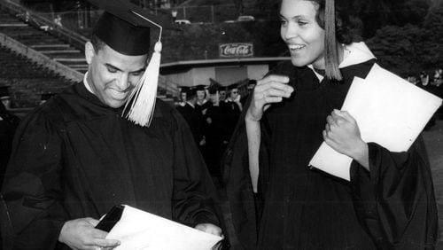 Hamilton Holmes and Charlayne Hunter examine diplomas awarded during the University of Georgia's 160th commencement in Athens on June 2, 1963. (AP)