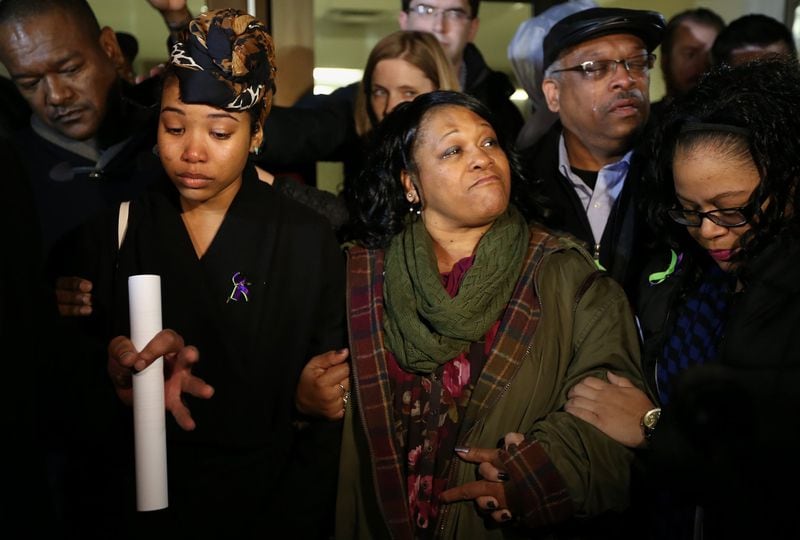 January 21, 2016 Decatur — Members of Anthony Hill’s family including his girlfriend Bridget Anderson, left, and mother Carolyn Baylor Giummo, center, talk to the media and supporters outside of the DeKalb County courthouse after District Attorney Robert James announced that the grand jury had indicted Officer Robert Olsen for shooting and killing Hill. Ben Gray / bgray@ajc.com