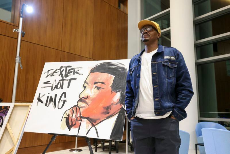 Artist Dakoro Edwards reacts after creating a live painting depicting Dexter King at Sandy Springs City Hall. The reception kicked off the City of Sandy Springs’ tribute to Black History Month. (Jason Getz / jason.getz@ajc.com)