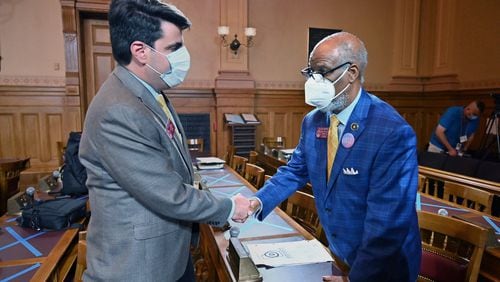 Rep. Chuck Efstration (R-Dacula), left, and Rep. Calvin Smyre (D-Columbus) shake hands as they wait for a press conference after HB 426 passed the House on day 37 of the legislative session at Georgia State Capitol on Tuesday, June 23, 2020. HB-426 passed. The bill would implement stiffer penalties if those guilty of crimes are found to have been motivated by hate. (Hyosub Shin / Hyosub.Shin@ajc.com)