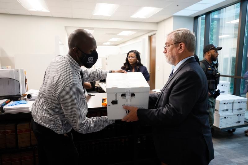 Workers at Atlanta City Hall seal boxes containing over 100,000 signatures with a petition by opponents of the police and firefighter training center who want the project placed on a ballot for public consideration. Miguel Martinez /miguel.martinezjimenez@ajc.com