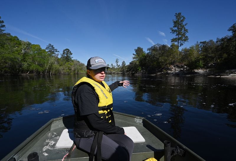 Emily Floore, the executive director of St. Mary's Riverkeepers, steers a boat along the river near MacClenny, Fla. The headwaters of the 130-mile waterway are located south of the Okefenokee Swamp and the proposed mining site in South Georgia. Staff photo by Hyosub Shin / Hyosub.Shin@ajc.com