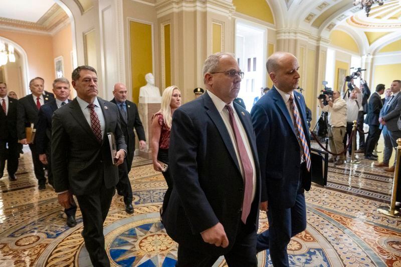 Acting-Clerk of the House Kevin McCumber, right, and House Sergeant-at-Arms William McFarland, followed by House Impeachment managers deliver the Secretary Mayorkas Impeachment Articles to the Senate on Monday, April 15, 2024, in Washington. (AP Photo/Kevin Wolf)