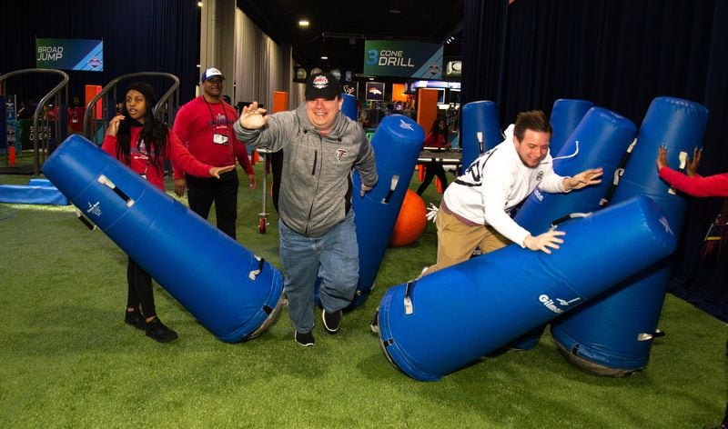 Brendan Schultz (left) and his brother Conner fight through tackling dummies during the Super Bowl Experience at the World Congress Center on Sunday, January 27, 2019. (Photo:  STEVE SCHAEFER / SPECIAL TO THE AJC)