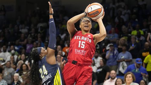 Atlanta Dream guard Allisha Gray (15) shoots as Dallas Wings guard Arike Ogunbowale (24) defends during the first half of Game 2 of a first-round WNBA basketball playoff series Tuesday, Sept. 19, 2023, in Arlington, Texas. (AP Photo/Tony Gutierrez)