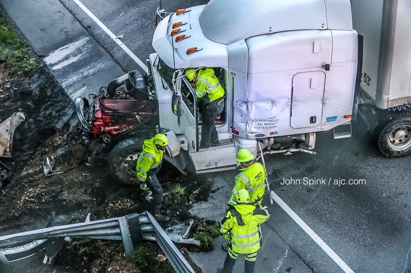 A crash that collected 13 vehicles was caused when traffic on I-20 East lagged and a tractor-trailer was unable to stop to avoid rear-ending another vehicle, according to police. JOHN SPINK / JSPINK@AJC.COM