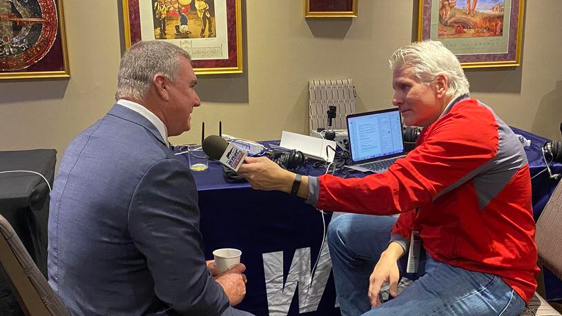 Georgia State coach Shawn Elliott (left) talks with radio host David Schultz of Sports Radio 105.5 in Mobile, Ala.
