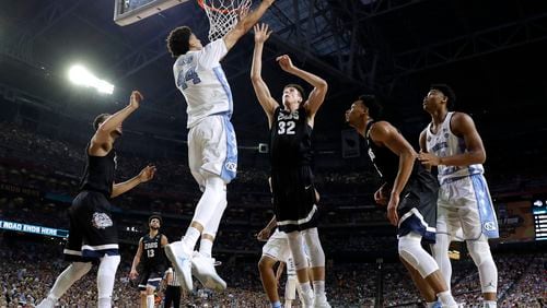 North Carolina forward Justin Jackson (44) shoots over Gonzaga forward Zach Collins (32) during the first half in the finals of the Final Four NCAA college basketball tournament, Monday, April 3, 2017, in Glendale, Ariz. (AP Photo/Mark Humphrey)