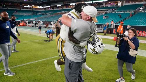 Georgia Tech head coach Brent Key picks up running back Jamal Haynes as they celebrate their 23-20 win over Miami in an NCAA college football game, Saturday, Oct. 7, 2023, in Miami Gardens, Fla. (AP Photo/Wilfredo Lee)