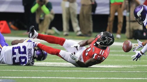 112915 ATLANTA: -- Falcons wide receiver Julio Jones canâ€™t hold on to a Matt Ryan pass as he is leveled by Vikings cornerback Xavier Rhodes during the first half in a football game on Sunday, Nov. 29, 2015, in Atlanta. Curtis Compton / ccompton@ajc.com