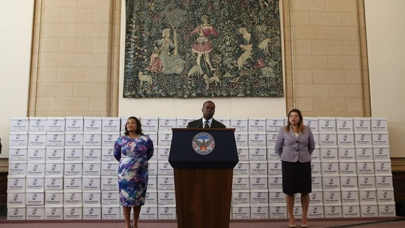 Then-Mayor Kasim Reed stands at the podium in front of boxes of documents his office released in February 2017 in response to open records requests for information tied to the federal corruption investigation at City Hall. AJC FILE PHOTO