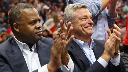 Hawks owner Tony Ressler (right) and Atlanta Mayor Kasim Reed applaude the Hawks during a 111-101 victory over the Washington Wizards in Game 4 of a first-round series on Monday, April 24, 2017, in Atlanta. (Curtis Compton/ccompton@ajc.com)